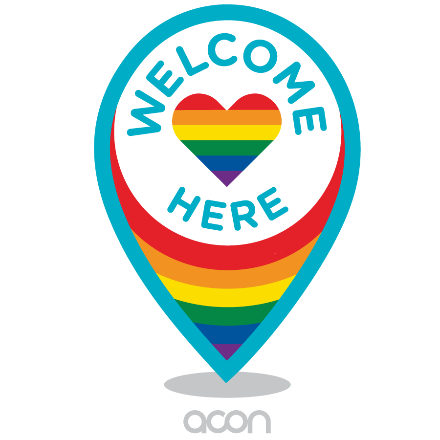 Welcome Here logo. There are rainbow pride colours and the words 